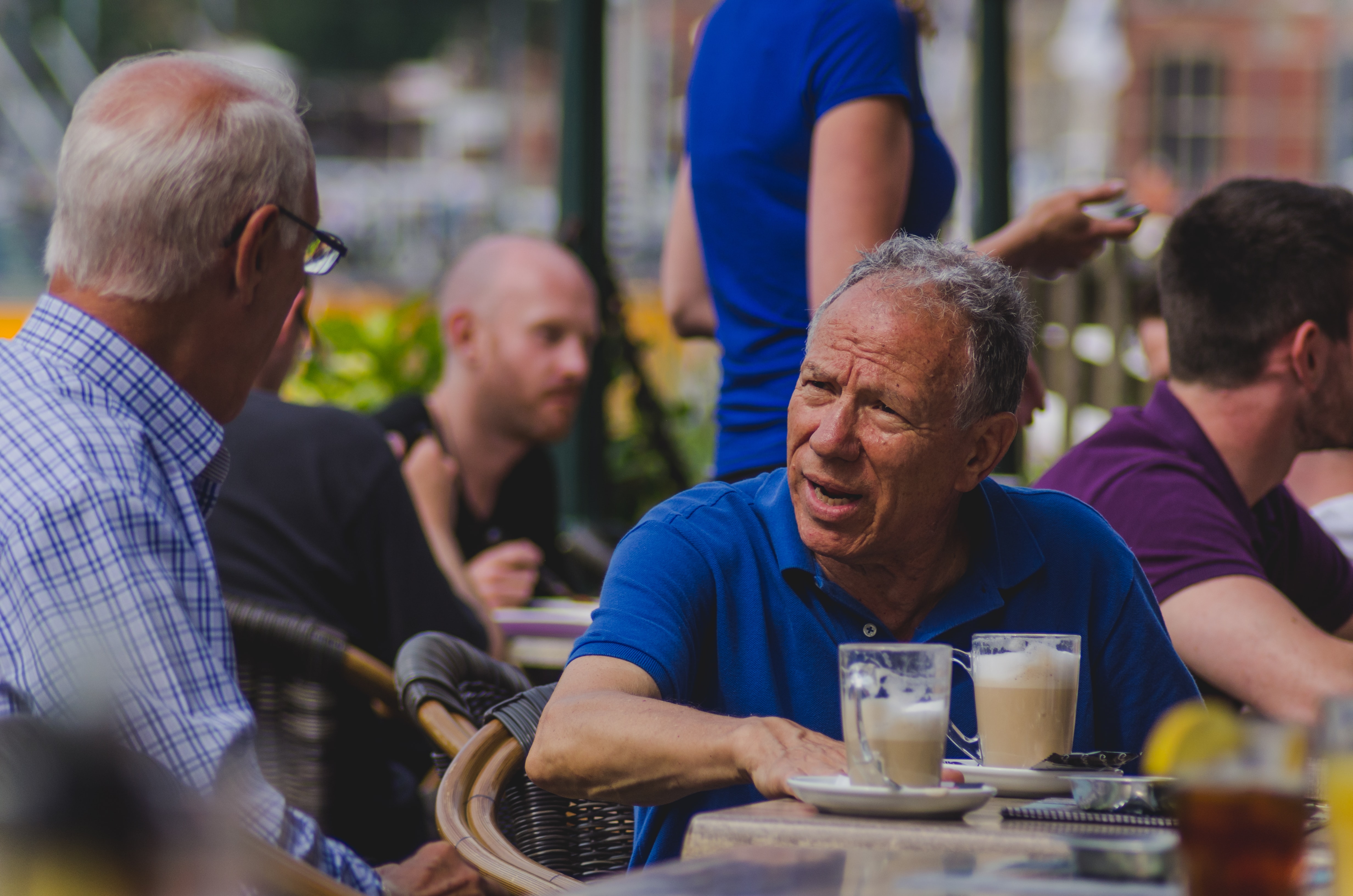 A man talking in a coffee shop.